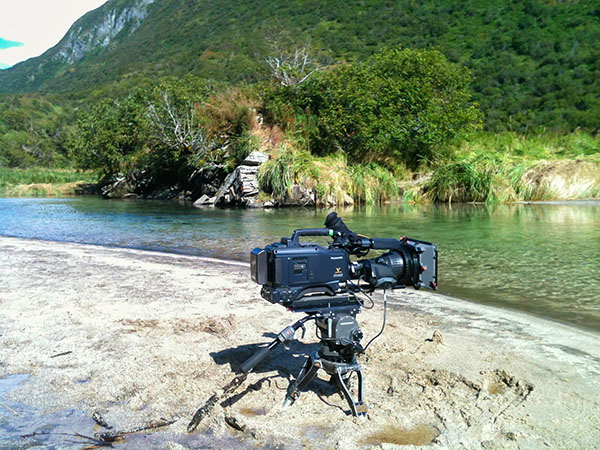 film camera set up along the shore of Alaskan river